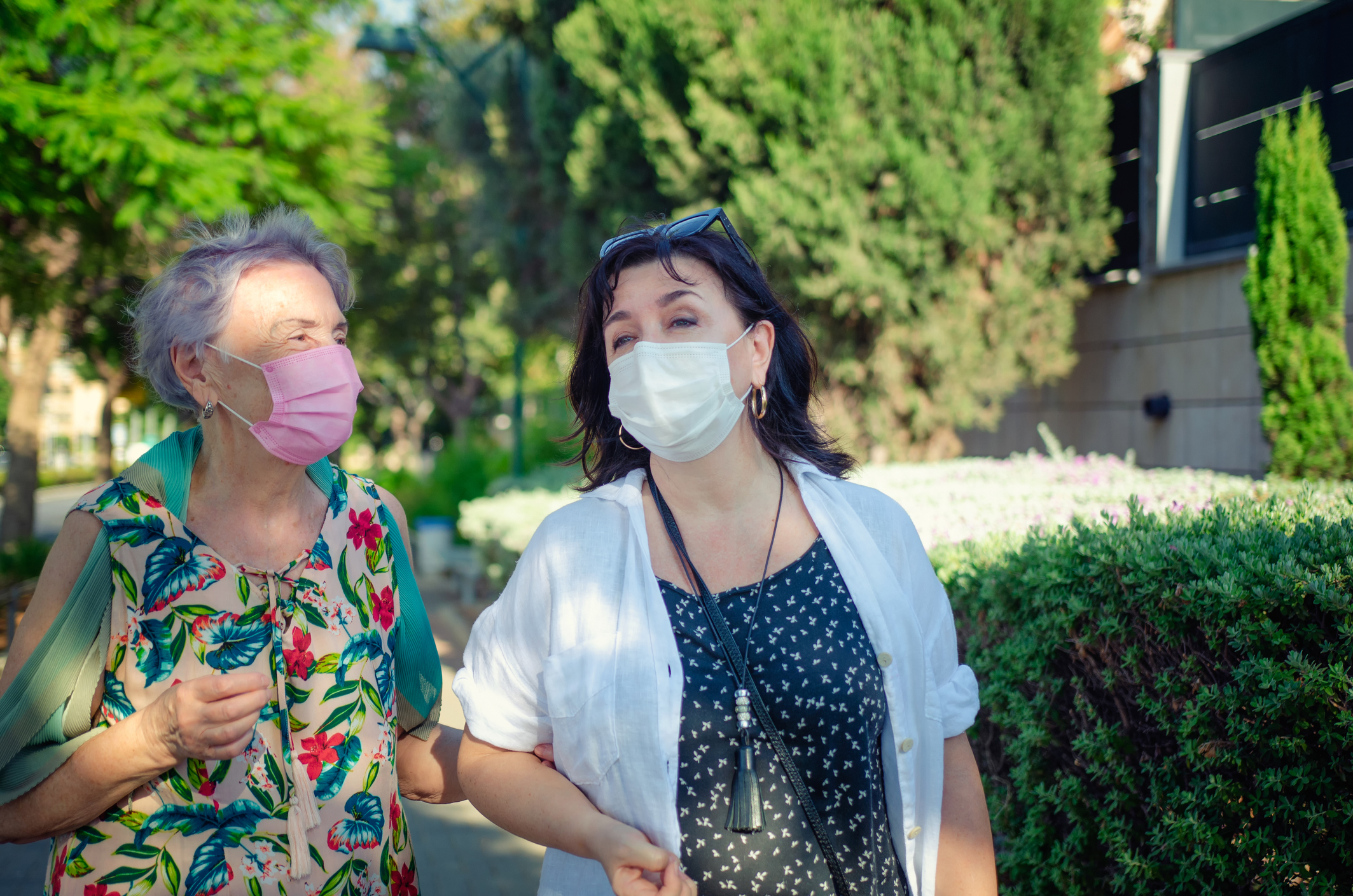 Care giver and senior wearing  facemask